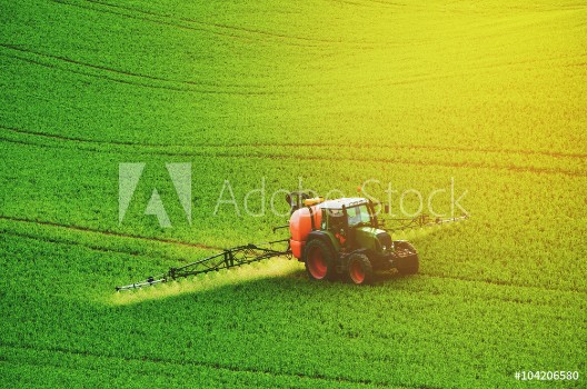 Picture of Farm machinery spraying insecticide to the green field agricultural natural seasonal spring background